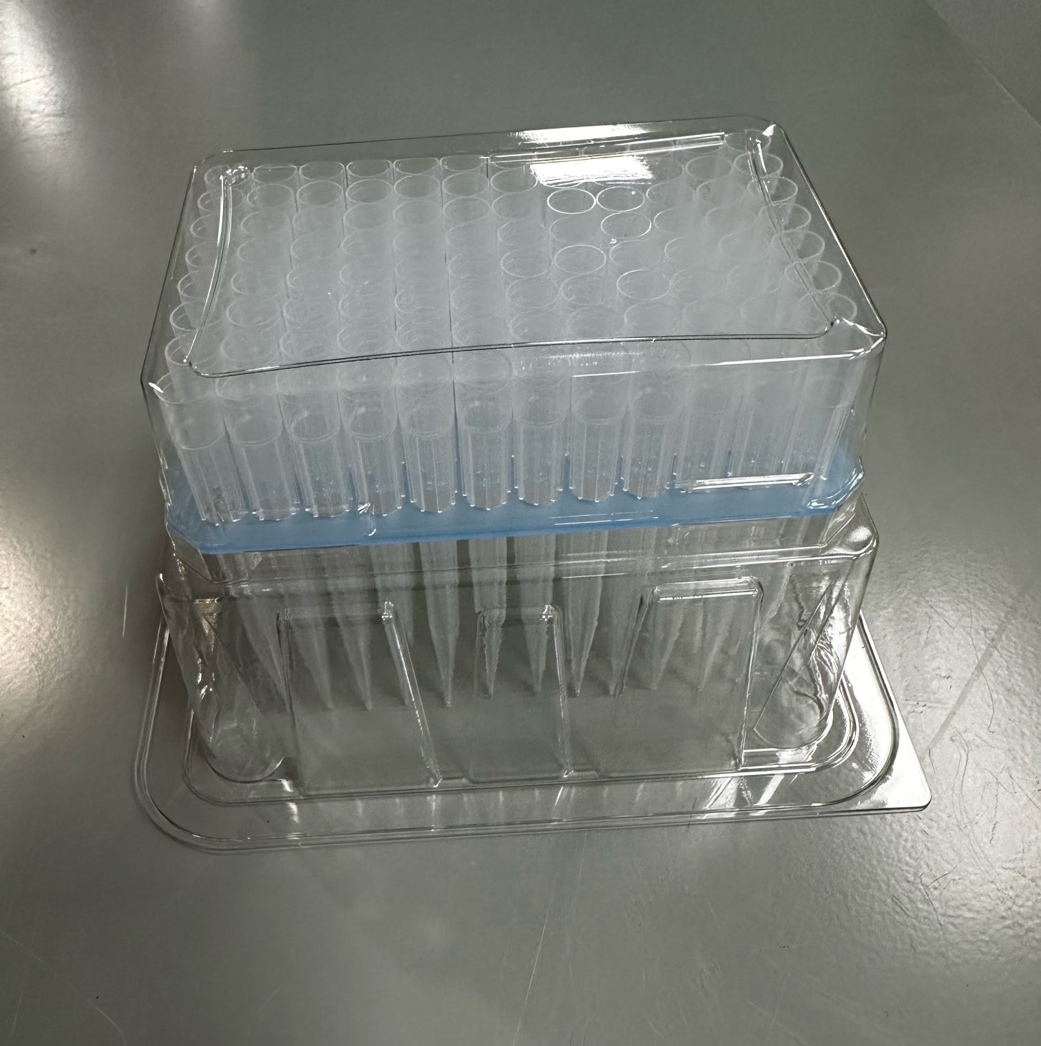 Case of pipette tips made from translucent plastic and sealed in a clear plastic 