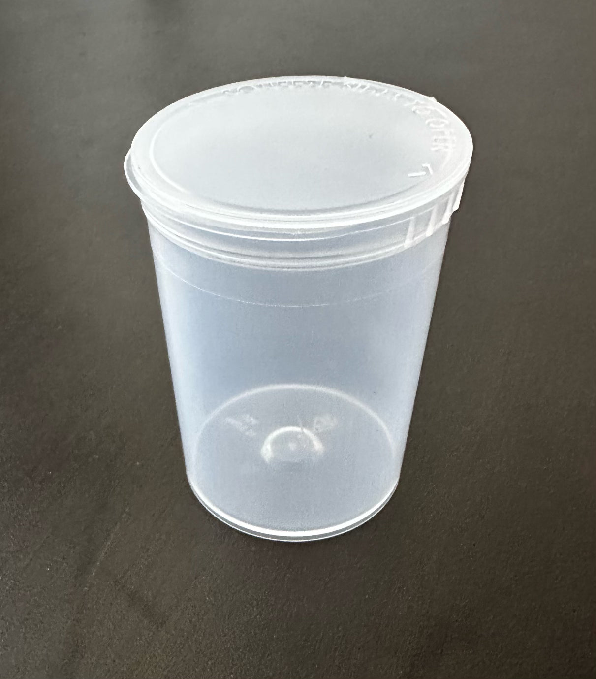A clear plastic bottle with a pop top lid, designed for storing medical supplies and vitamins.